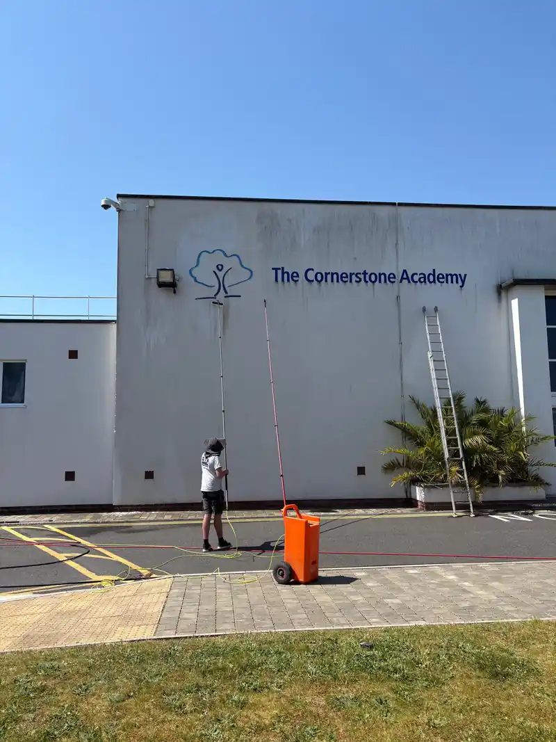 Cleaning a school building with a water-fed pole