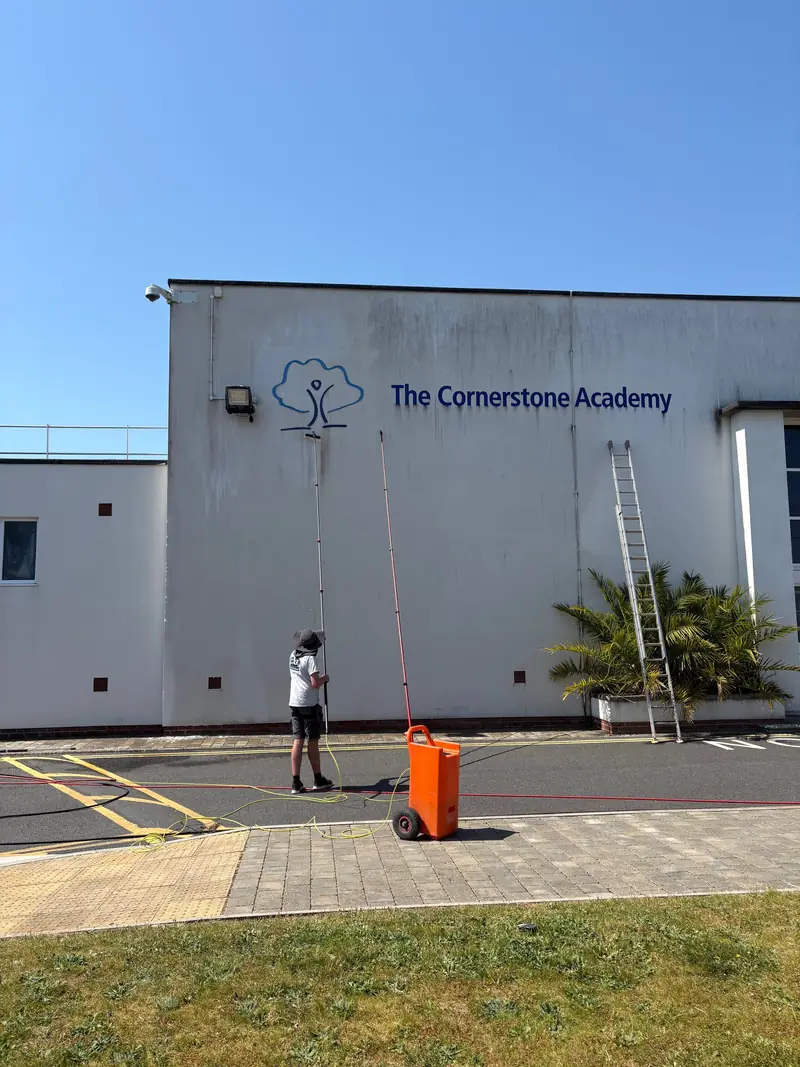 Cleaning a school building with a water-fed pole