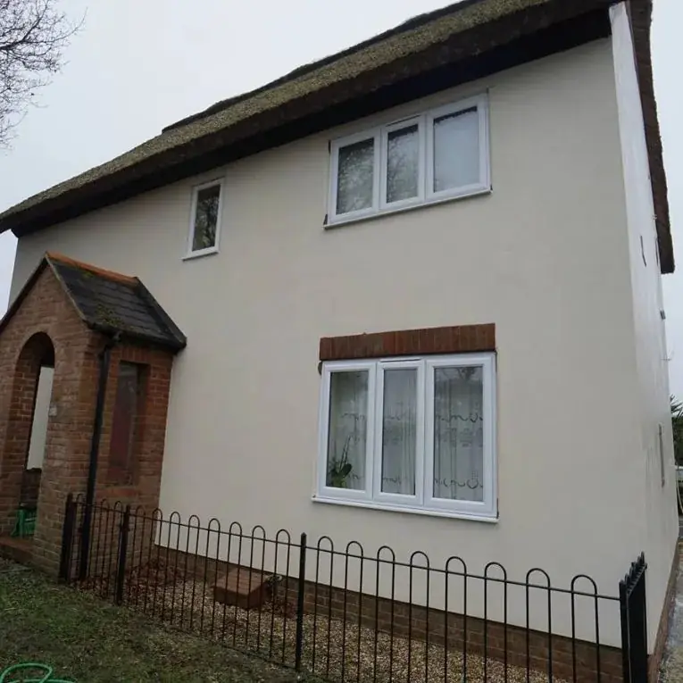 The same house after a render clean, with bright, clean walls